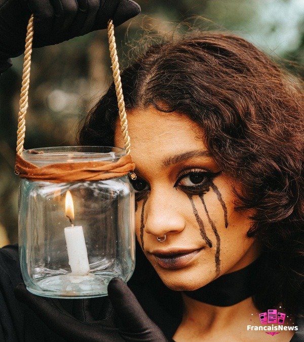 Déguisement Halloween : 25 idées originales pour 2026 Femme au maquillage Halloween gothique tenant une lanterne allumée, idée déguisement Halloween 2026